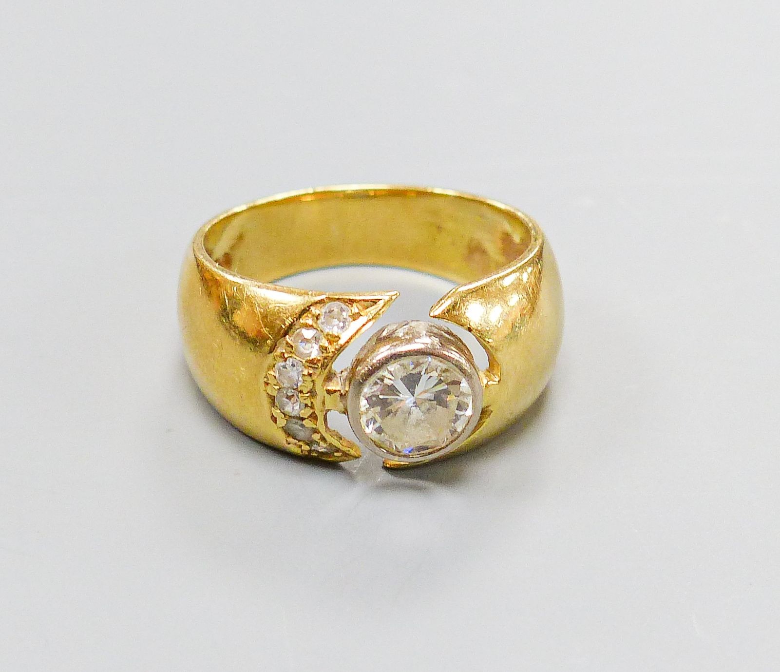 A modern 750 yellow metal and single stone diamond ring, with diamond set open work setting, size M, gross 6.4 grams.